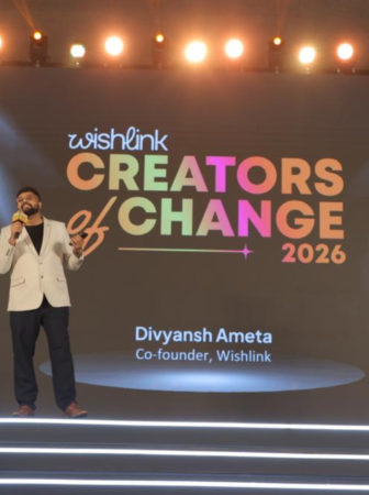 Speaker on a brightly lit stage delivering a talk at Creators of Change 2026 (Wishlink), with a colorful backdrop reading ‘Creators of Change 2026’.
