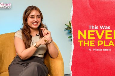 Woman smiling and gesturing while sitting in a mustard chair during an interview; logo visible in the top-left and a red panel with title text on the right.